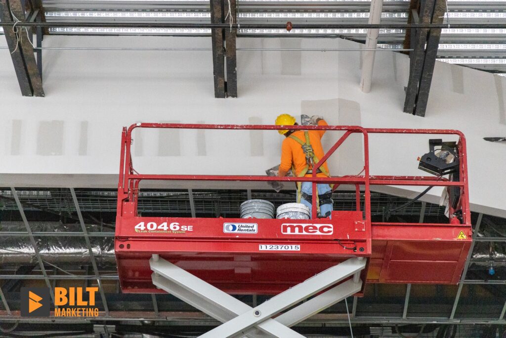 Construction worker floating a wall on a scissor lift in San Antonio, Texas